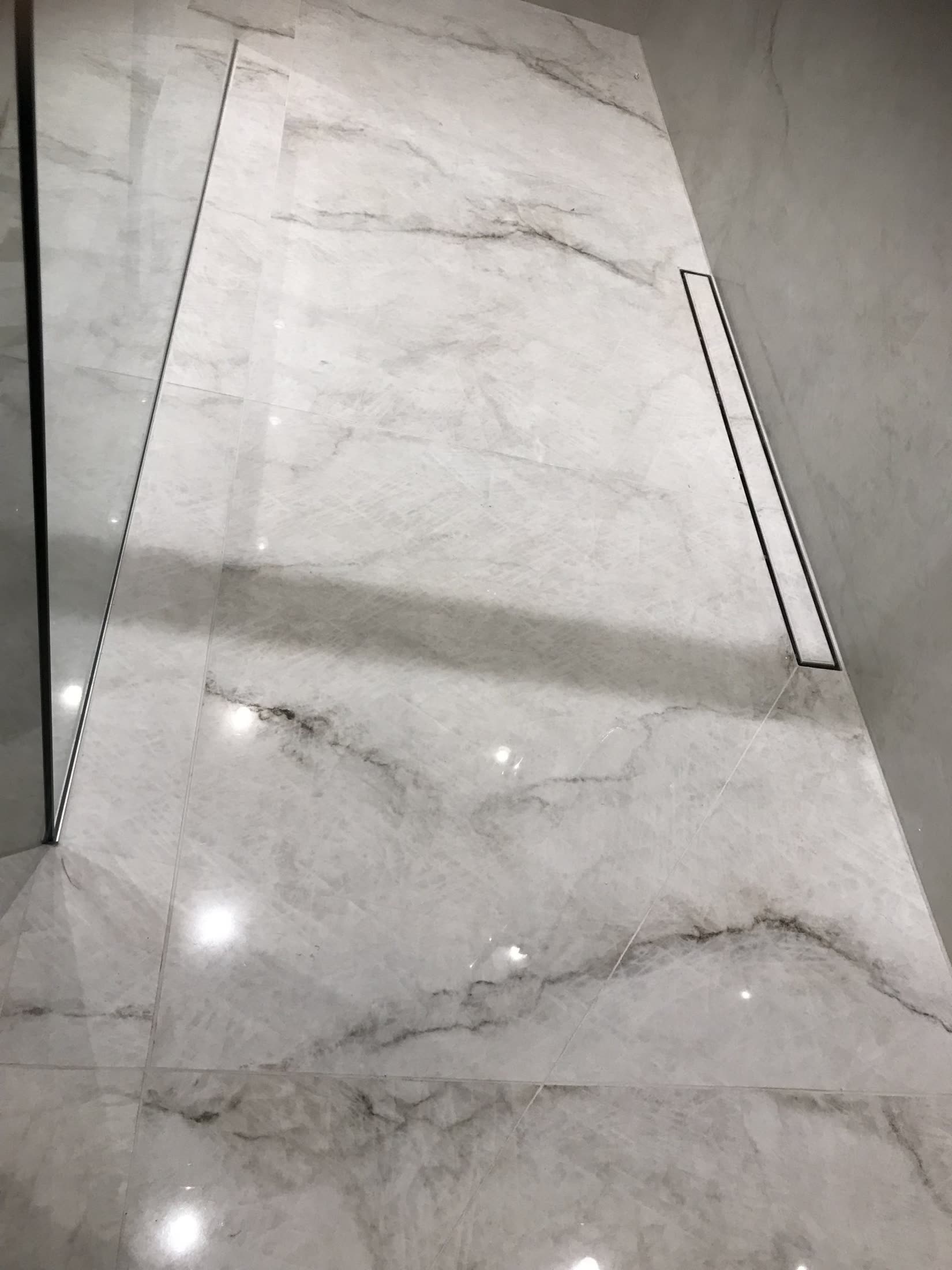 Glossy white marble tiles in a modern bathroom