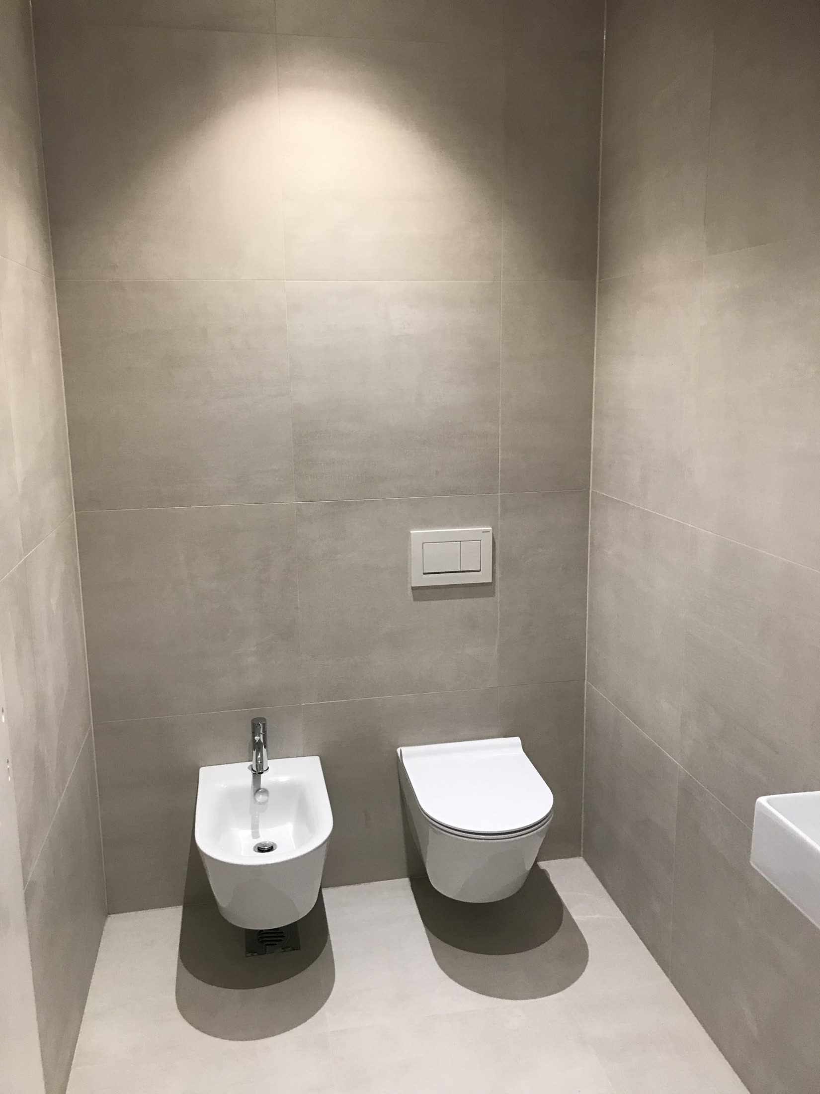 Modern bathroom with gray tiled walls